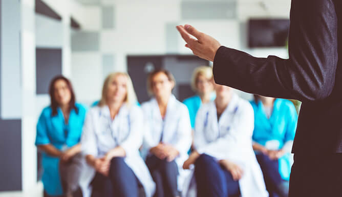 person speaking to a seated group