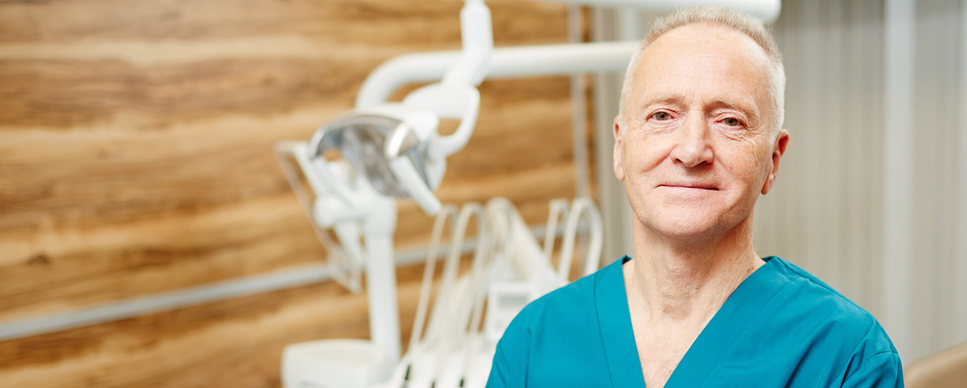 dentist standing in front of a dental work station