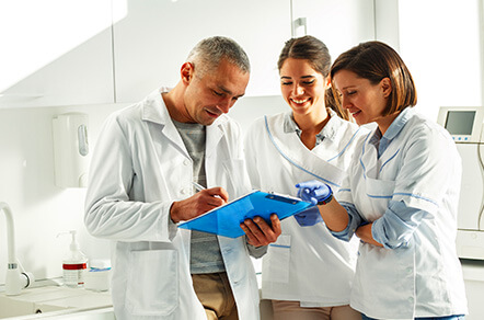 dental staff looking at a chart together
