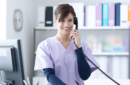 dental receptionist talking on the phone