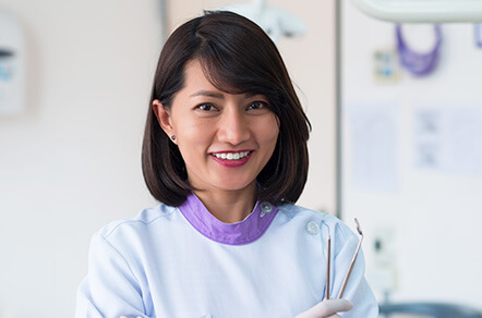 dental professional holding dental tools